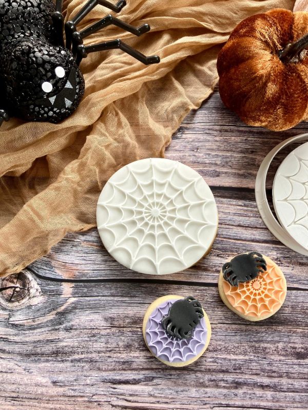 Mini Halloween cookie cutter and fondant stamp set including spider, web and cobweb on a Halloween-themed plate, 3D-printed from biodegradable food-safe PLA