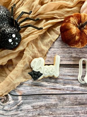 Boo cookie cutter and fondant stamp displayed on a Halloween-themed plate, 3D-printed from biodegradable food-safe PLA