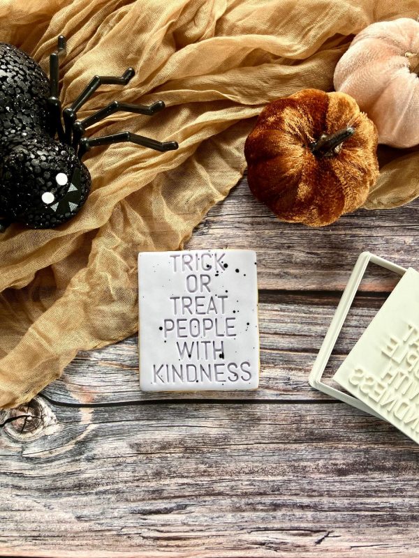 7cm Trick or Treat People with Kindness cookie cutter and fondant stamp, displayed on a Halloween-themed surface, 3D-printed from biodegradable food-safe PLA