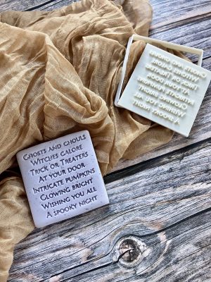 Halloween spell cookie cutter and fondant stamp set displayed on a dark plate with autumn decorations, 3D-printed from biodegradable food-safe PLA