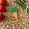 Carrot cookie cutter & embosser with green top on mat