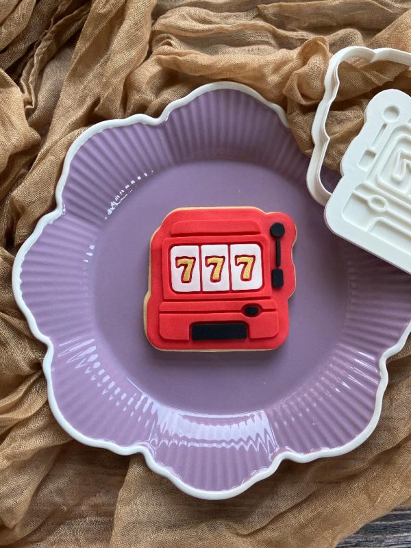 777 slot machine cookie cutter and fondant stamp on purple plate