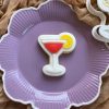Cocktail cookie cutter and fondant stamp on purple plate