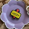 Lucky sign cookie cutter and fondant stamp set featuring St. Patrick's design displayed on a purple plate, 3D-printed from biodegradable food-safe PLA