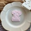 Cherry number one cookie cutter and fondant embosser on beige plate