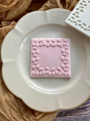 Cherry frame border fondant stamp cookie on plate