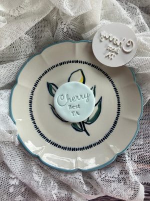 Cherry Best TA cookie stamp embossed fondant design on cookie with message "Cherry Best TA"