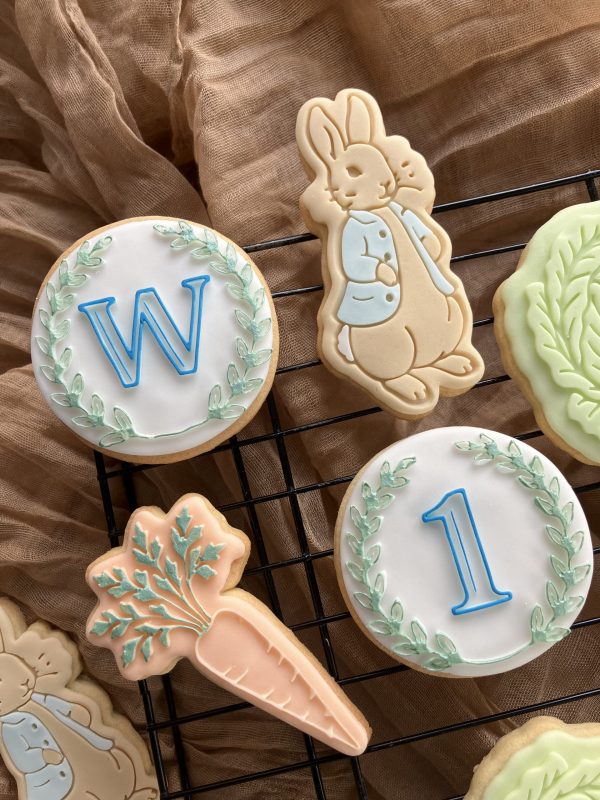 Custom letter and number fondant stamp embossers displayed on cookies, 3D-printed from biodegradable PLA