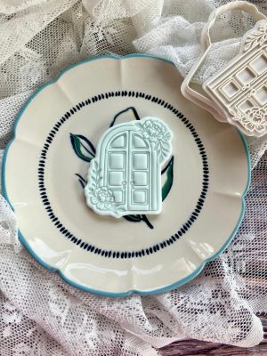 Grecian door cookie cutter and fondant stamp on a plate 3D-printed from food-safe PLA
